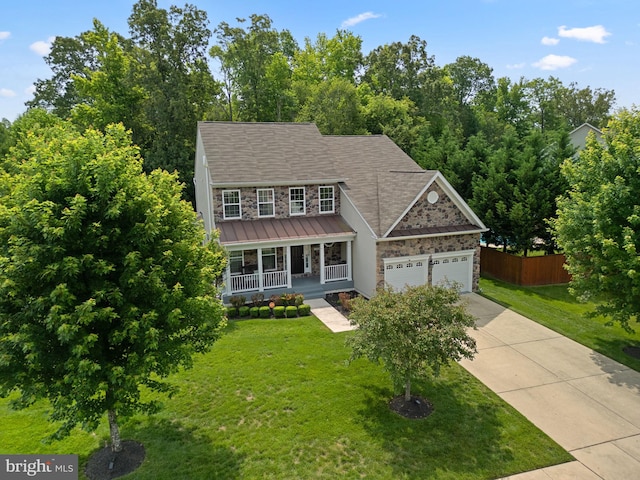 17202 Madrillon Way, Accokeek, MD 20607 - view of front of house with stone siding, covered porch, concrete driveway, an attached garage, and a standing seam roof