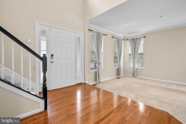 17202 Madrillon Way, Accokeek, MD 20607 - carpeted foyer featuring wood finished floors, stairs, and crown molding