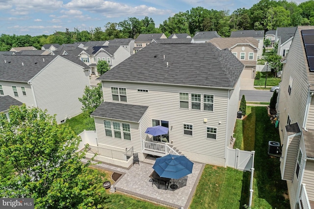 7928 Meridian Dr, Pasadena, MD 21122 - back of house featuring a patio area, a gate, a residential view, a shingled roof, and cooling unit