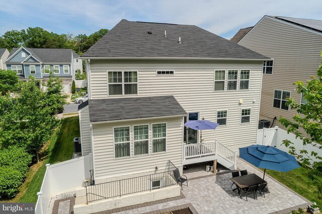 7928 Meridian Dr, Pasadena, MD 21122 - rear view of property featuring a fenced backyard, a patio area, roof with shingles, and a wooden deck