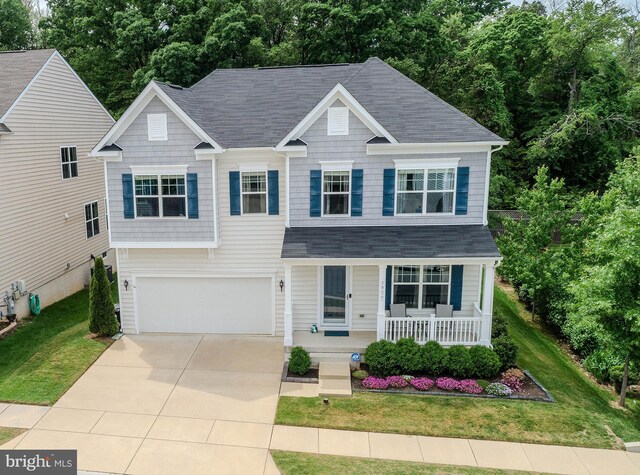 7928 Meridian Dr, Pasadena, MD 21122 - view of front of property with covered porch, a shingled roof, and a garage