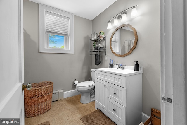bathroom with vanity, a baseboard heating unit, and toilet