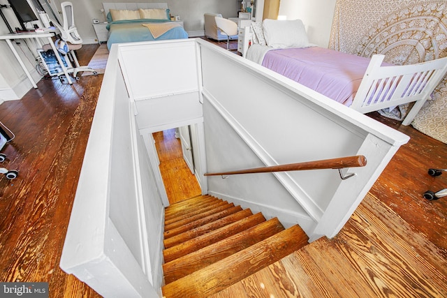 stairway with hardwood / wood-style floors