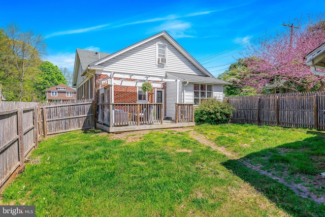 back of house featuring a fenced backyard, a yard, a pergola, and a deck