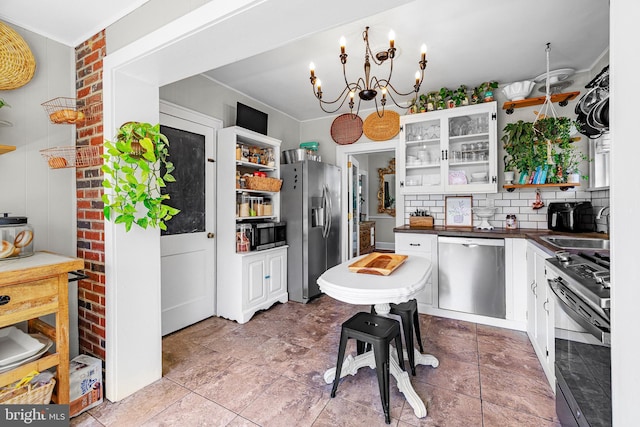 kitchen featuring dark countertops, appliances with stainless steel finishes, open shelves, and white cabinetry