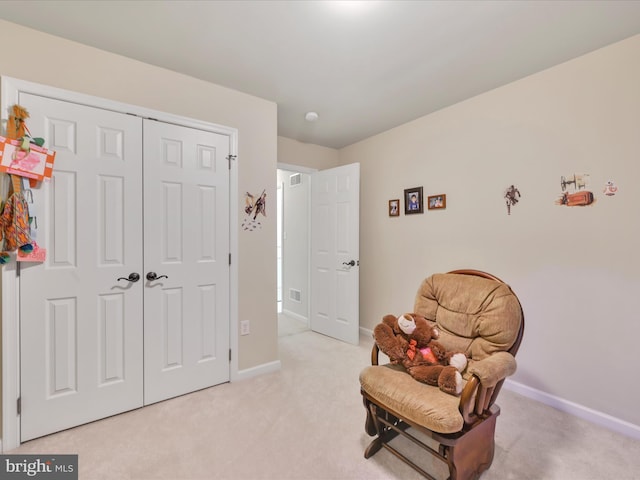 living area with baseboards, visible vents, and light carpet