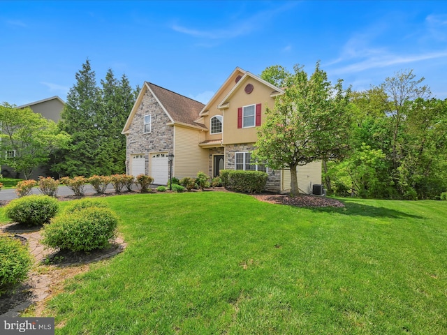 traditional home with a garage, a front lawn, stone siding, stucco siding, and central air condition unit
