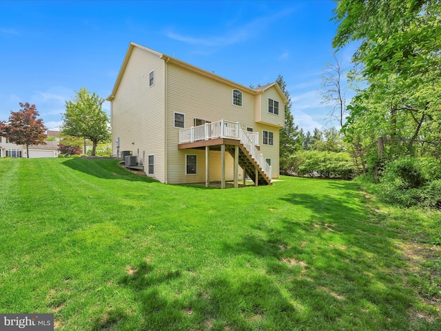 back of property with stairway, a deck, cooling unit, and a lawn