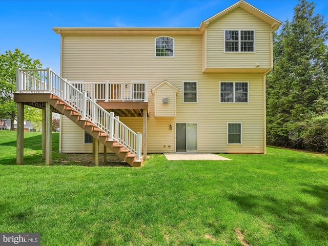 back of house featuring a lawn, stairs, a deck, and a patio