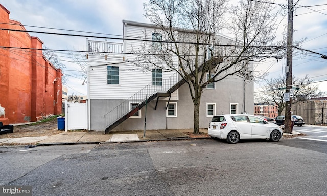 exterior space with stucco siding and stairs