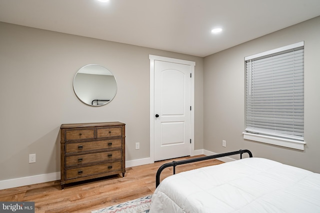 bedroom featuring baseboards, recessed lighting, and light wood finished floors