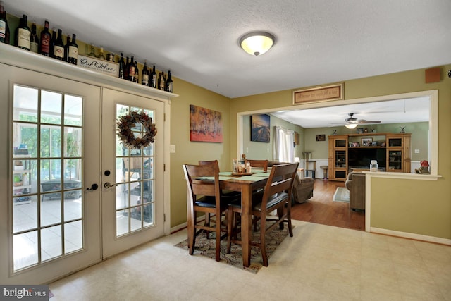 dining area with french doors, a ceiling fan, baseboards, and a textured ceiling