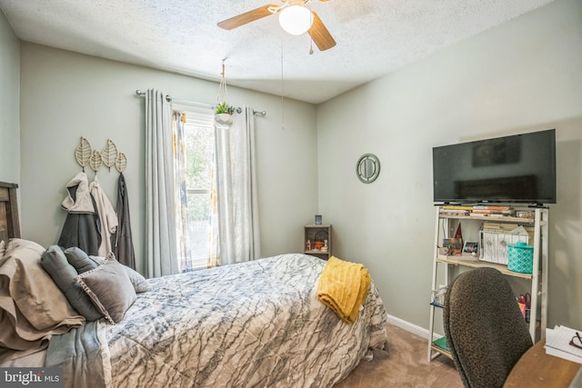 bedroom with baseboards, carpet flooring, a textured ceiling, and a ceiling fan