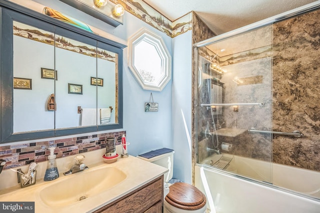 bathroom featuring vanity, toilet, a textured ceiling, tasteful backsplash, and combined bath / shower with glass door