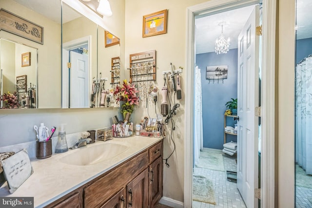 bathroom featuring vanity, tile patterned flooring, and a notable chandelier