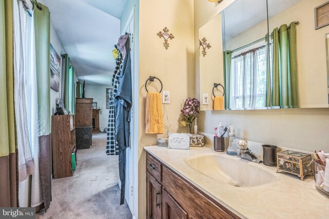 bathroom featuring vanity and a fireplace