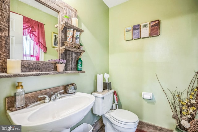 bathroom with toilet and a sink