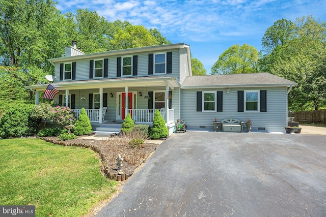 colonial inspired home with a front lawn, fence, covered porch, a chimney, and crawl space