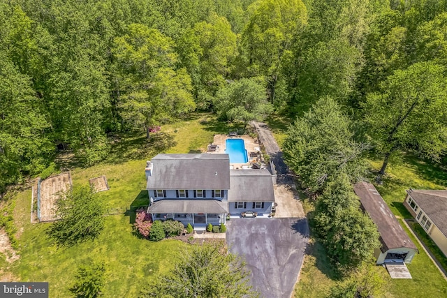 drone / aerial view with a wooded view