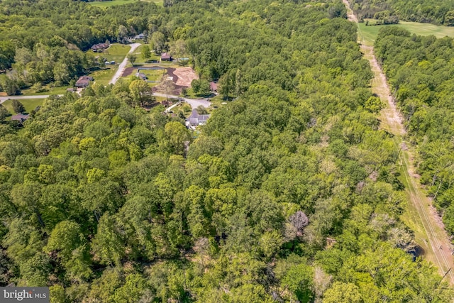 drone / aerial view featuring a forest view