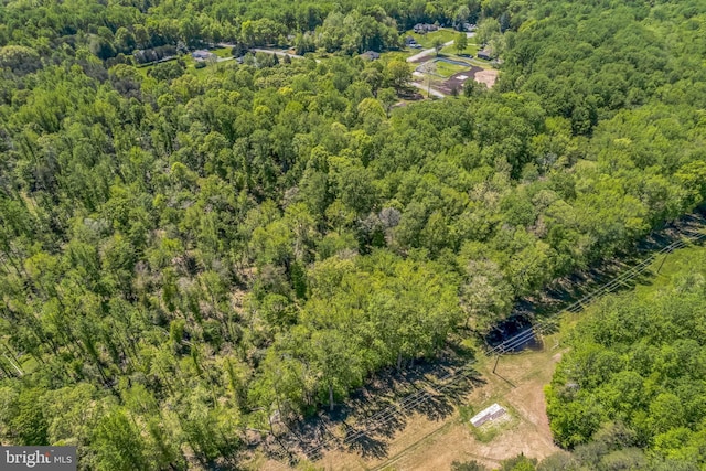 drone / aerial view with a wooded view