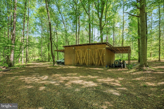 view of pole building featuring a forest view