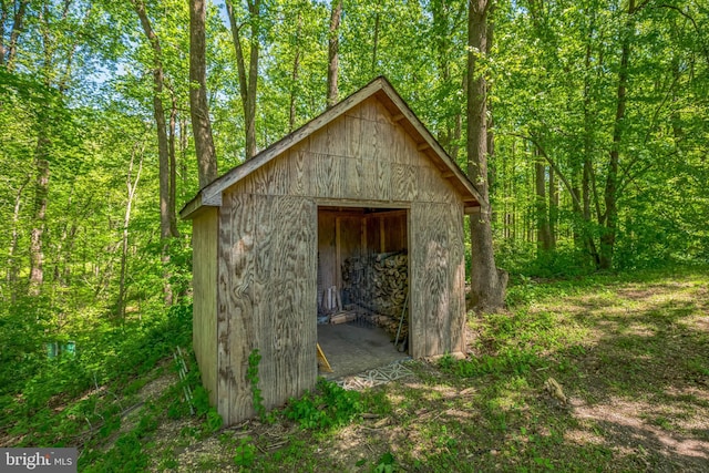 view of shed featuring a view of trees