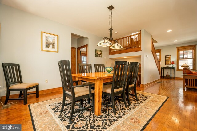 dining area with wood-type flooring, recessed lighting, and baseboards
