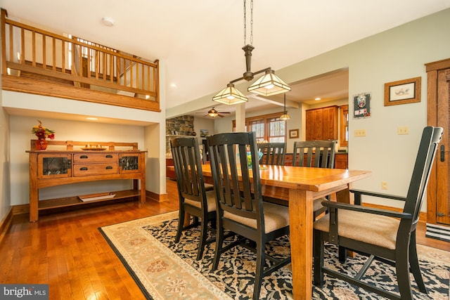 dining space with baseboards, ceiling fan, and hardwood / wood-style flooring