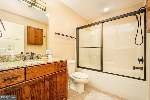 bathroom with tile patterned floors, vanity, toilet, and shower / bath combination with glass door