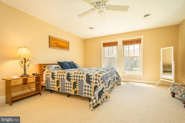 carpeted bedroom with baseboards, ceiling fan, and visible vents