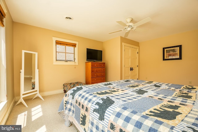 carpeted bedroom with ceiling fan, visible vents, baseboards, and a closet