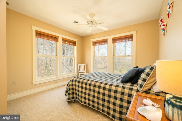 bedroom featuring carpet floors, a ceiling fan, and baseboards