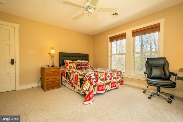 bedroom with baseboards, carpet flooring, a ceiling fan, and visible vents