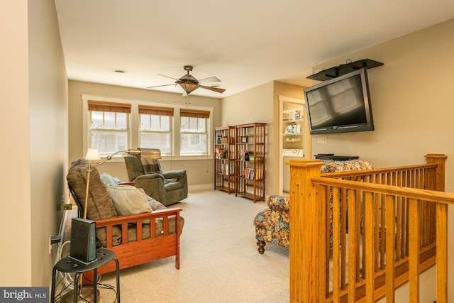 living area with carpet floors, baseboards, and ceiling fan