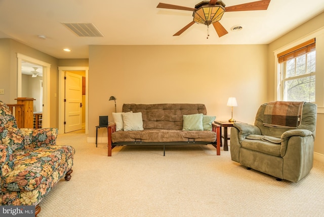 living area featuring carpet floors, ceiling fan, and visible vents