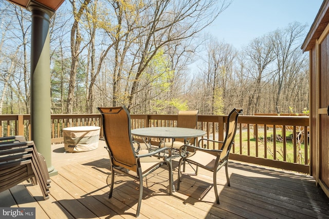 wooden terrace with outdoor dining space