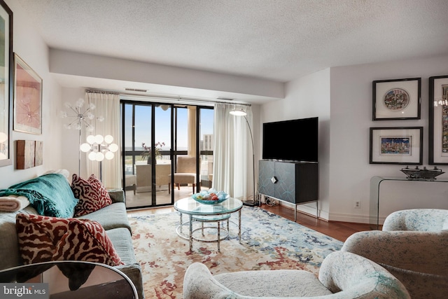 900 Stafford St N Unit 2222, Arlington, VA 22203 - living room featuring a textured ceiling, wood finished floors, visible vents, and baseboards