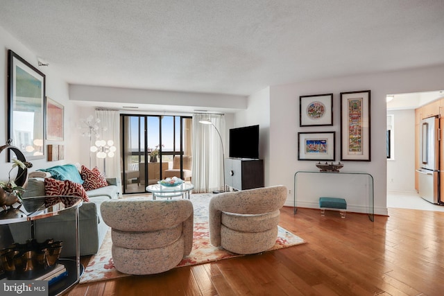 900 Stafford St N Unit 2222, Arlington, VA 22203 - living room featuring wood-type flooring, a textured ceiling, and baseboards