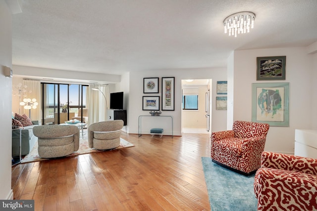 900 Stafford St N Unit 2222, Arlington, VA 22203 - living area featuring baseboards, an inviting chandelier, and wood-type flooring