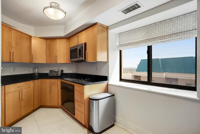 900 Stafford St N Unit 2222, Arlington, VA 22203 - kitchen with black appliances, a toaster, visible vents, and dark countertops