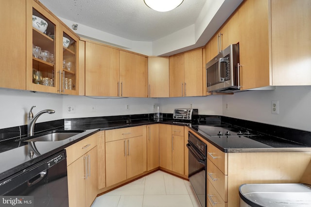 900 Stafford St N Unit 2222, Arlington, VA 22203 - kitchen with light tile patterned floors, a textured ceiling, glass insert cabinets, a sink, and black appliances