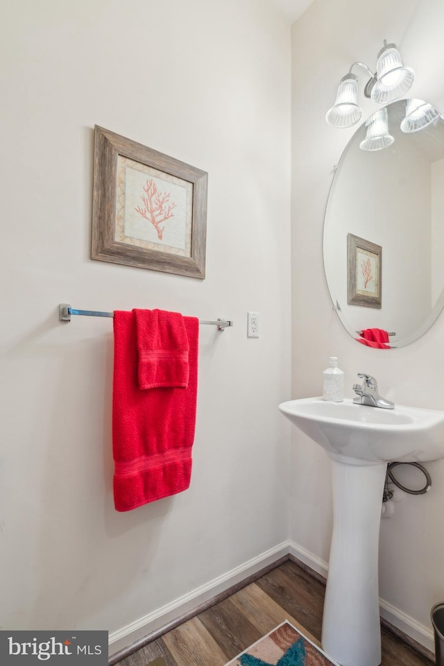 bathroom featuring a sink, baseboards, and wood finished floors