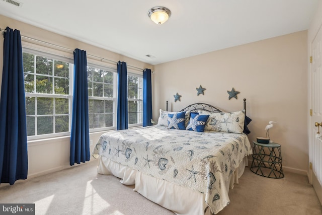 bedroom with carpet flooring, baseboards, and visible vents