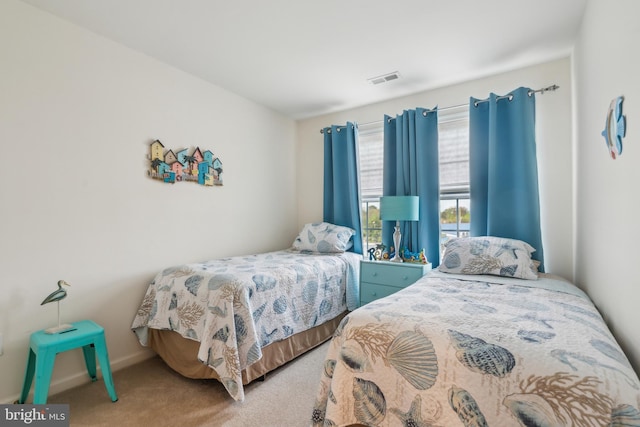 bedroom featuring baseboards, carpet flooring, and visible vents