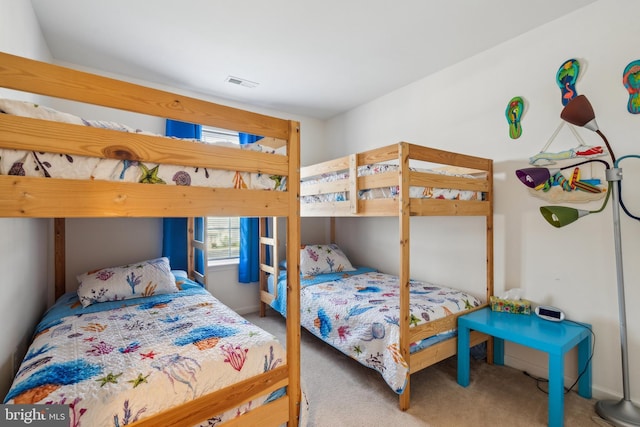 bedroom with carpet floors, baseboards, and visible vents
