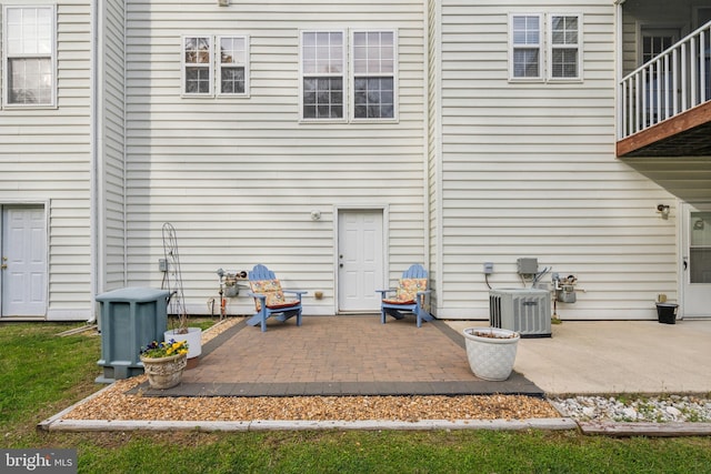 rear view of house with a patio and central air condition unit