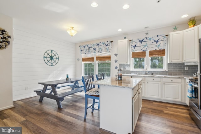 kitchen featuring white cabinets, backsplash, and a wealth of natural light
