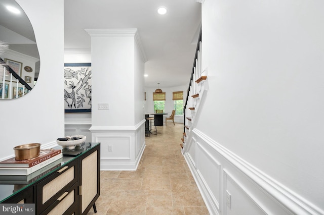 hallway featuring crown molding, stairway, a decorative wall, and recessed lighting