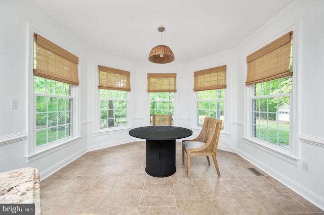 sunroom with tile patterned flooring, baseboards, and visible vents